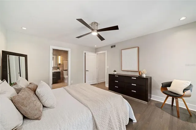 a bedroom with a large bed and a window