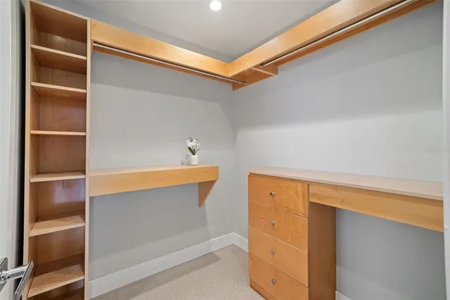a bathroom with a granite countertop sink a large mirror and a shower