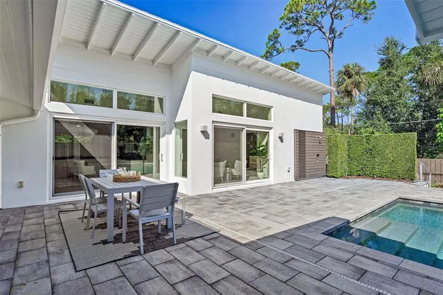a view of a fountain in front of a house with a swimming pool
