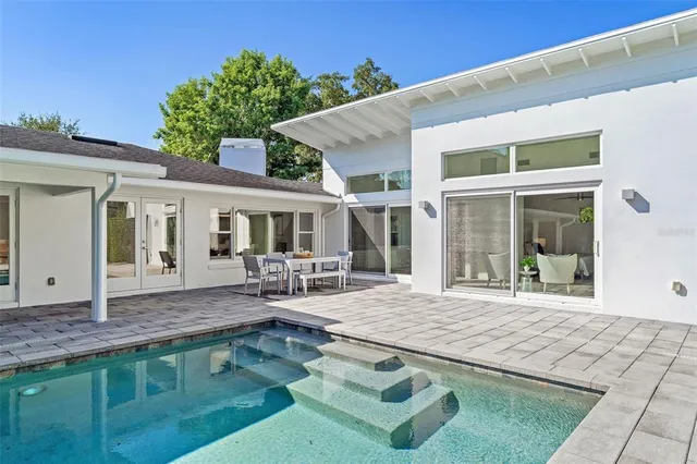 a view of backyard with furniture and a slide