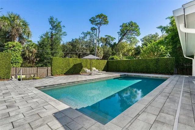 an aerial view of a house with a yard and garden