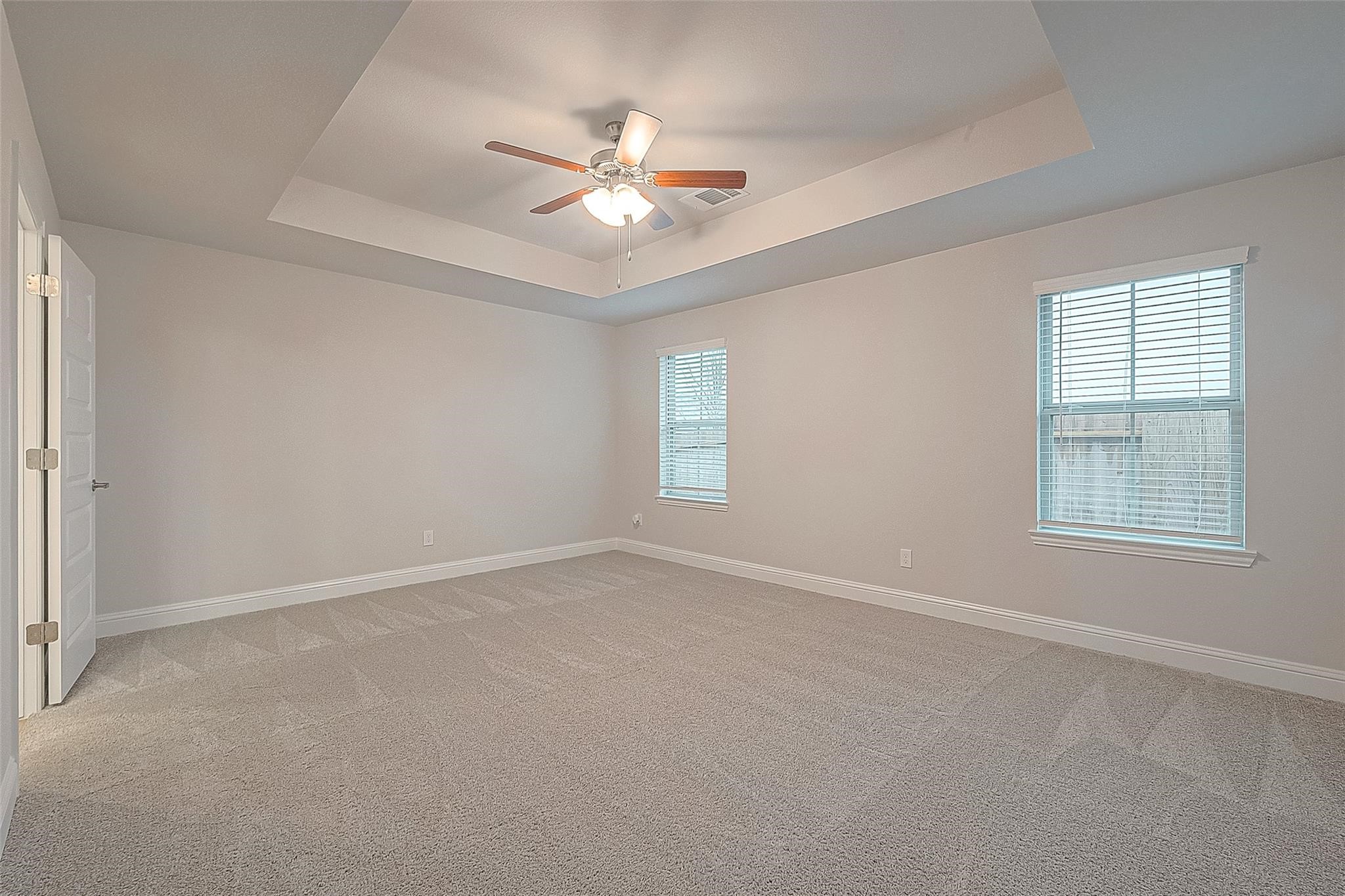 35 Greenbriar Loop Angleton, TX 77515 - Photo 6 of 9 an empty room with windows and fan