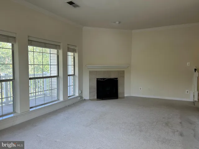 a view of an empty room with a fireplace
