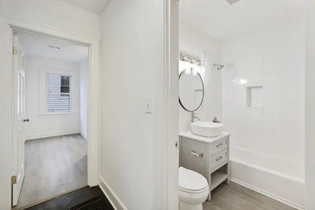 a bathroom with a toilet sink and mirror