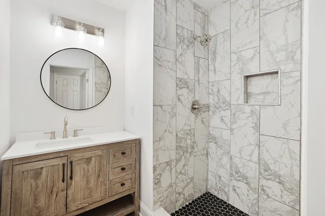 a bathroom with a sink a vanity and a mirror