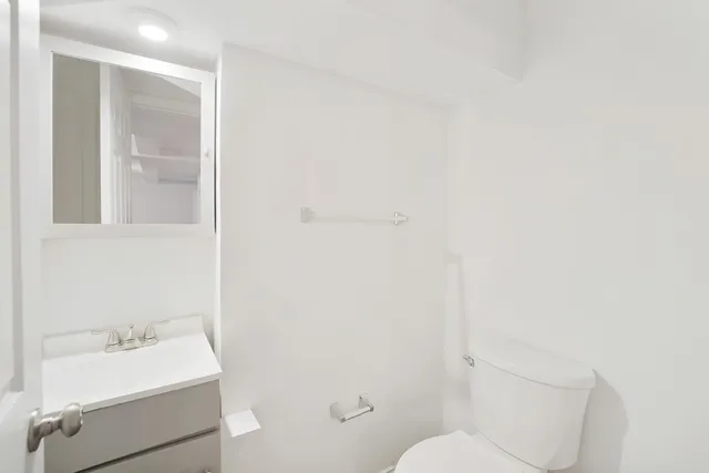a bathroom with a sink toilet and vanity