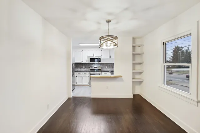 a room with wooden floors and white walls