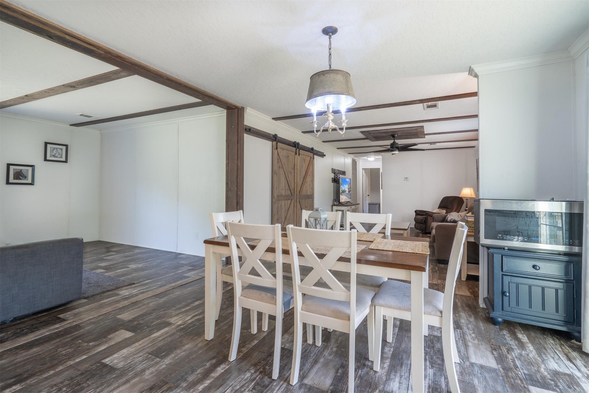76220 Dove Road Yulee, FL 32097 - Photo 19 of 48 a view of a dining room with furniture wooden floor and chandelier