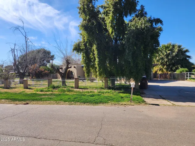 a kitchen with granite countertop a refrigerator and a stove top oven
