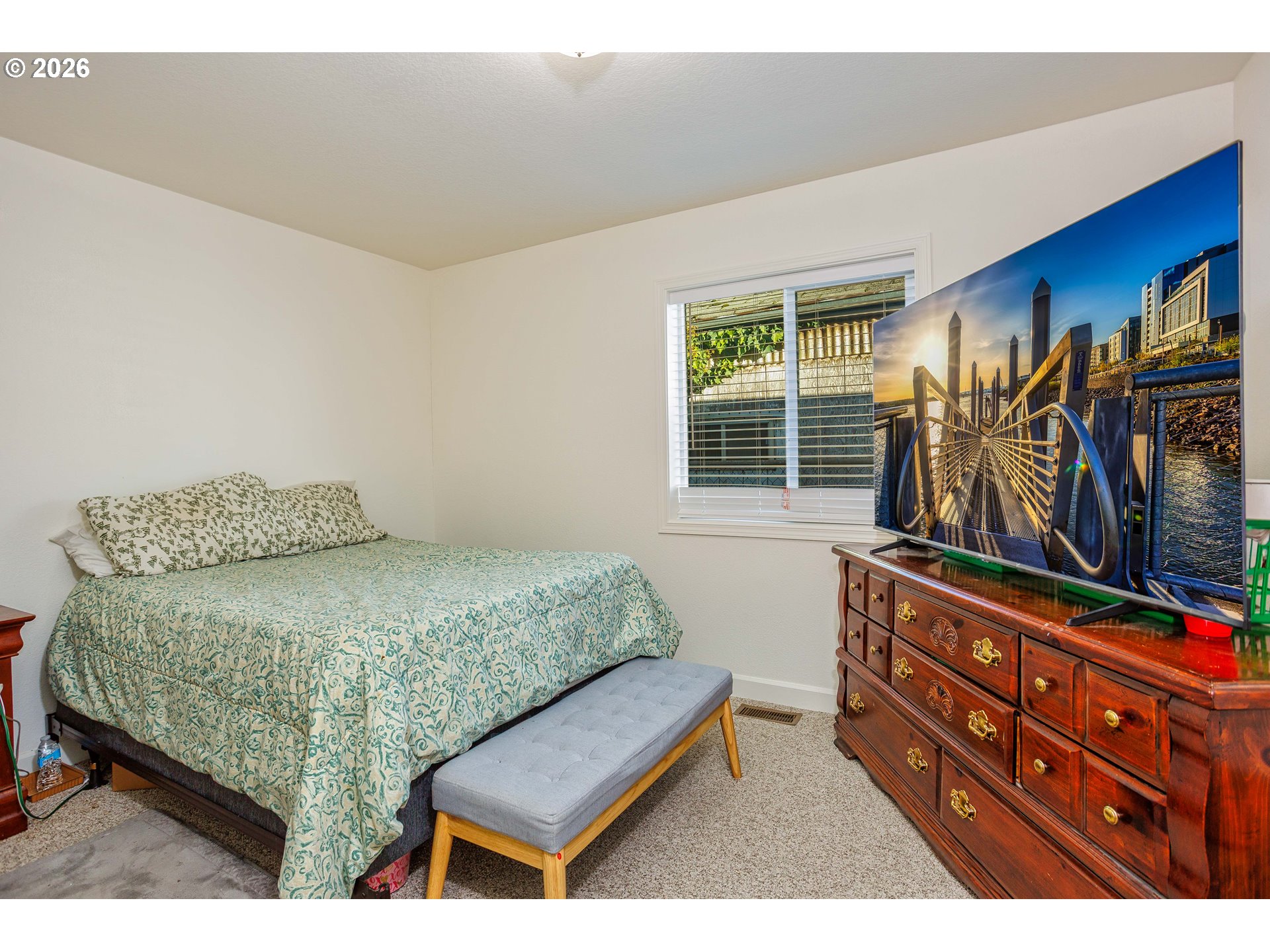 8715 Northeast Clackamas Street Portland, OR 97220 - Photo 17 of 25 a bedroom with a bed and a dresser