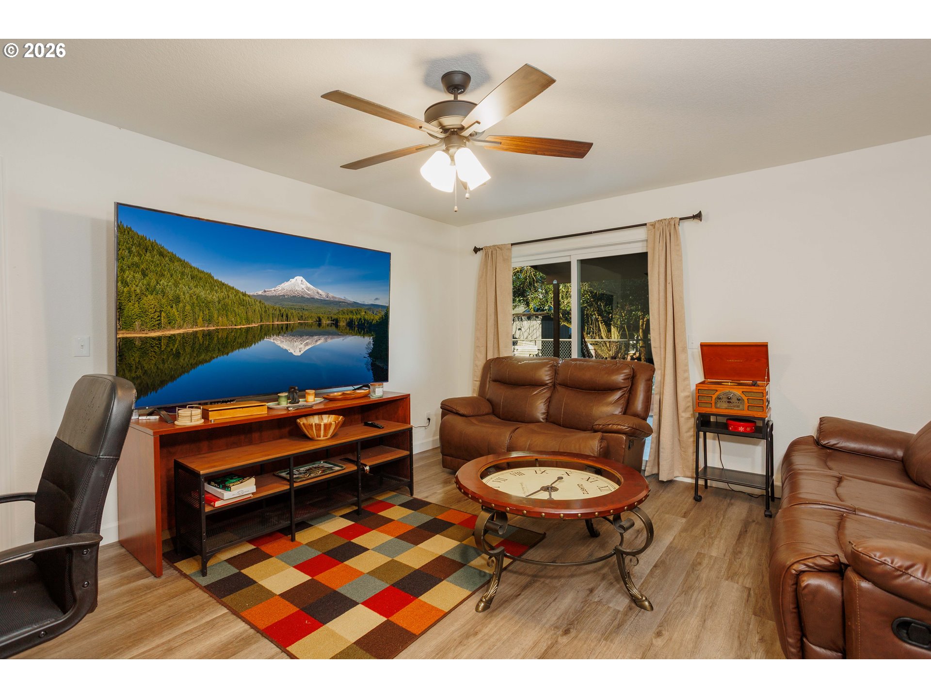 8715 Northeast Clackamas Street Portland, OR 97220 - Photo 18 of 25 a living room with furniture and a flat screen tv