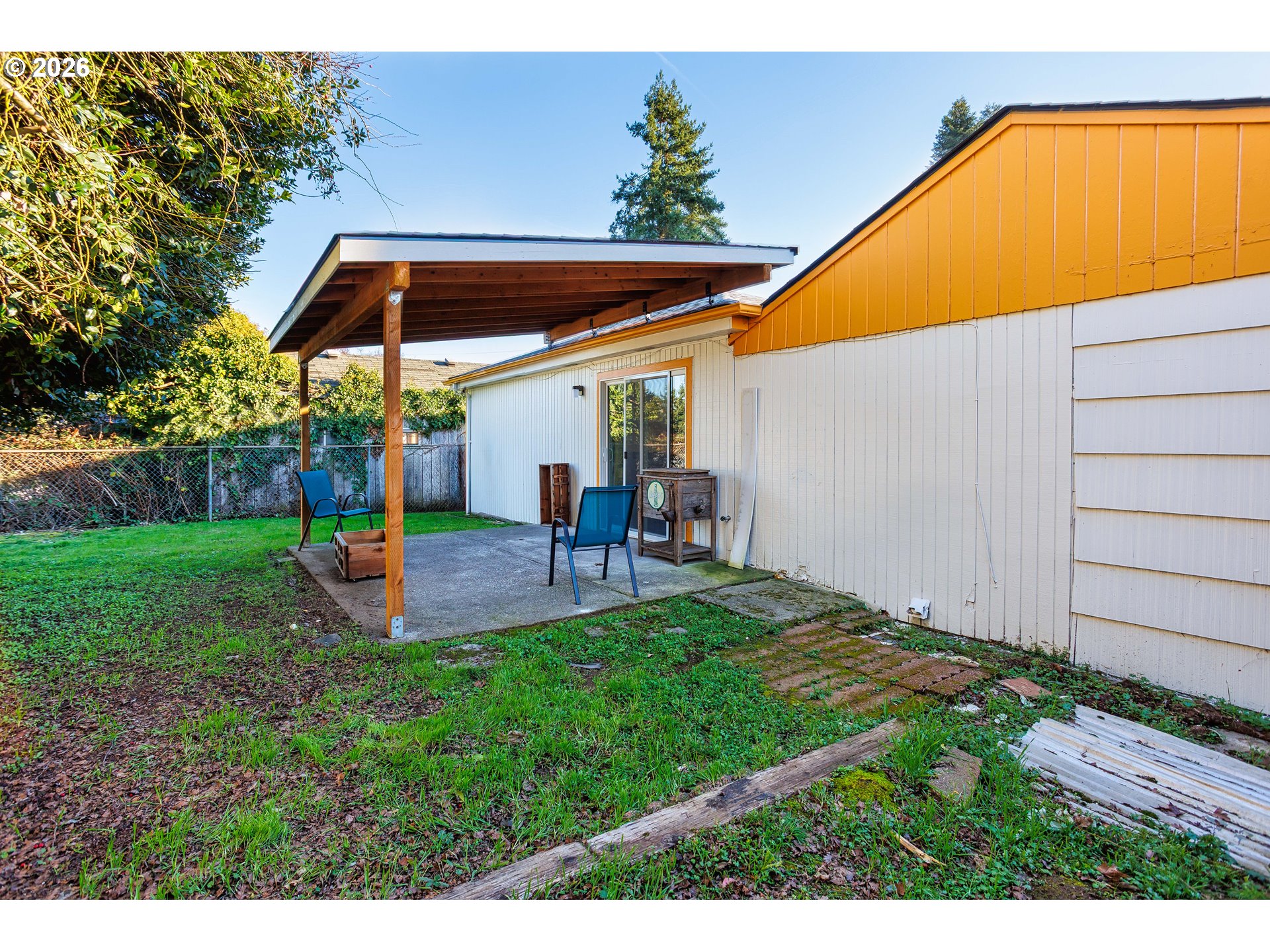 8715 Northeast Clackamas Street Portland, OR 97220 - Photo 25 of 25 a view of a backyard with table and chairs under an umbrella
