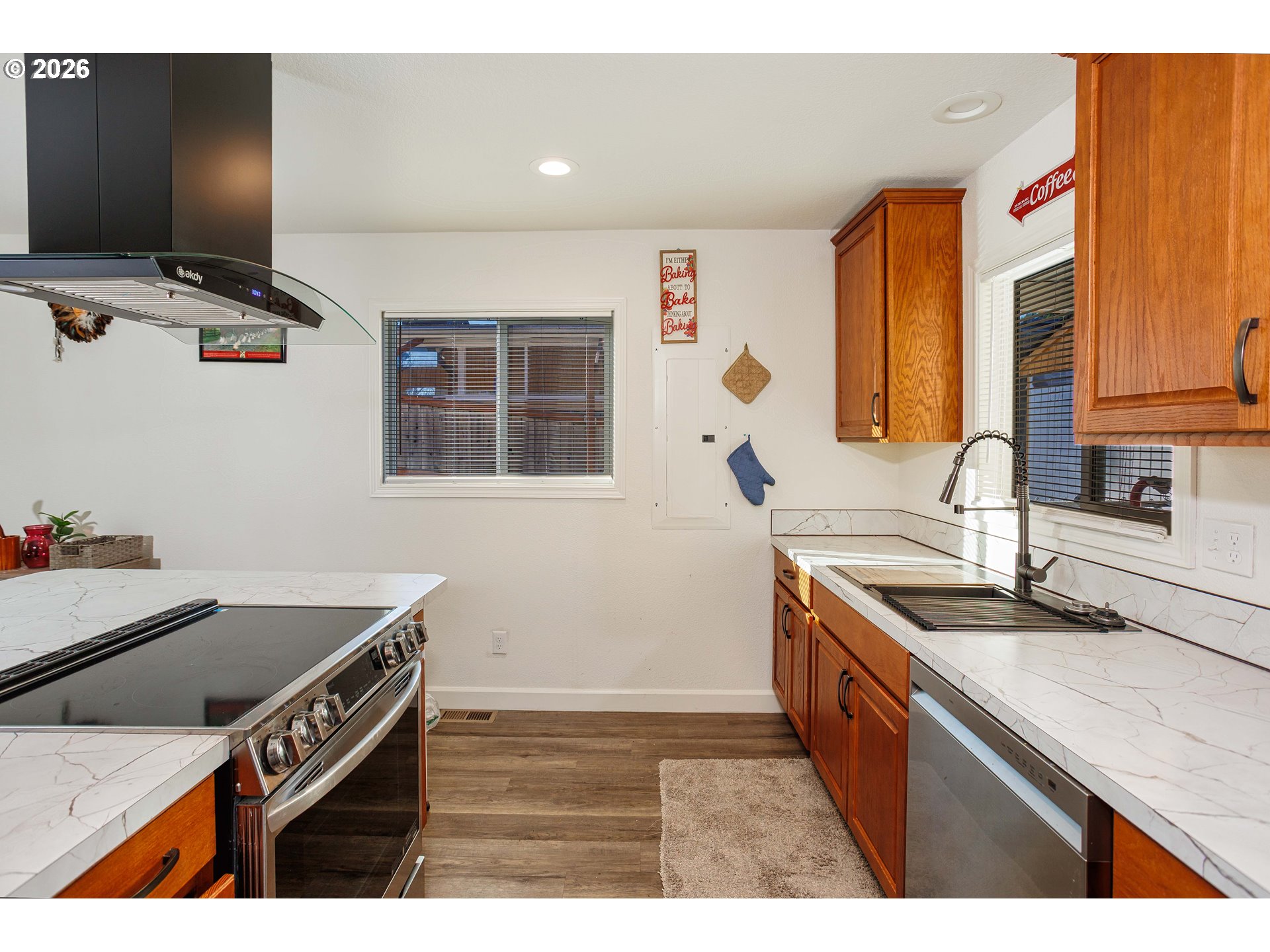 8715 Northeast Clackamas Street Portland, OR 97220 - Photo 9 of 25 a kitchen that has a sink and a stove in it