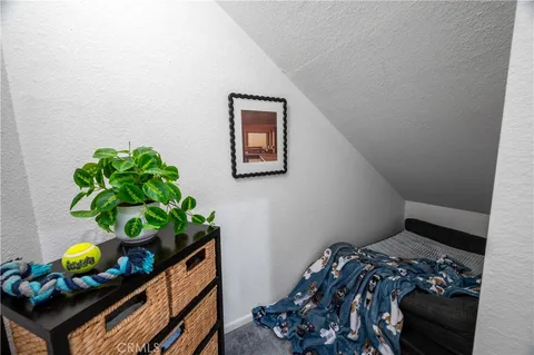 a bedroom with a bed a couch and a window