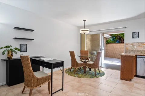a dining room with furniture and a chandelier