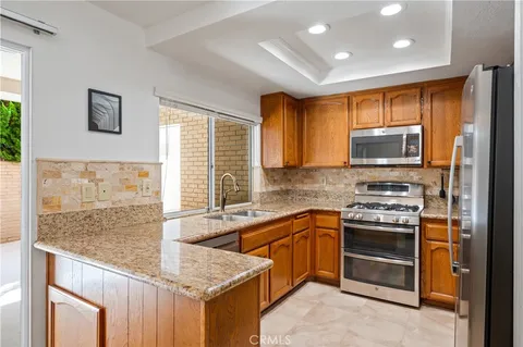 a kitchen that has a sink and a stove in it