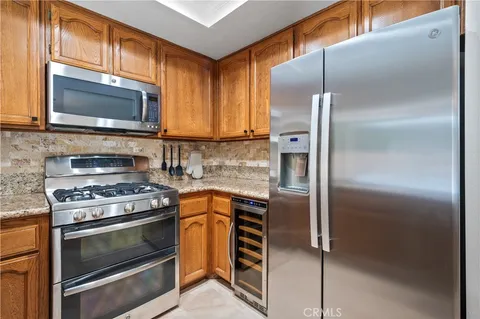 a kitchen with a refrigerator stove and microwave