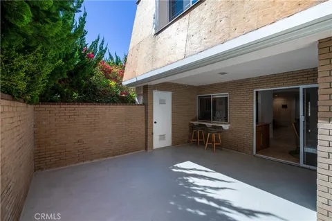 a backyard of a house with table and chairs