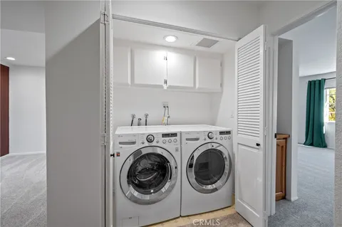 a view of a hallway with washer and dryer