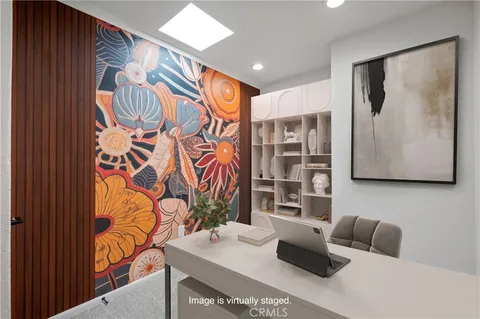 a living room with furniture and a painting on the wall