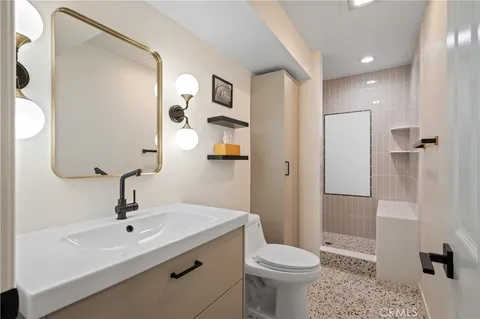 a bathroom with a sink toilet and shower