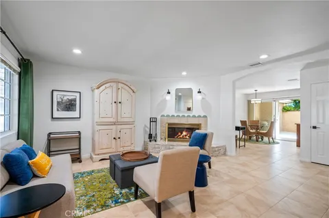 a living room with furniture fireplace and a table