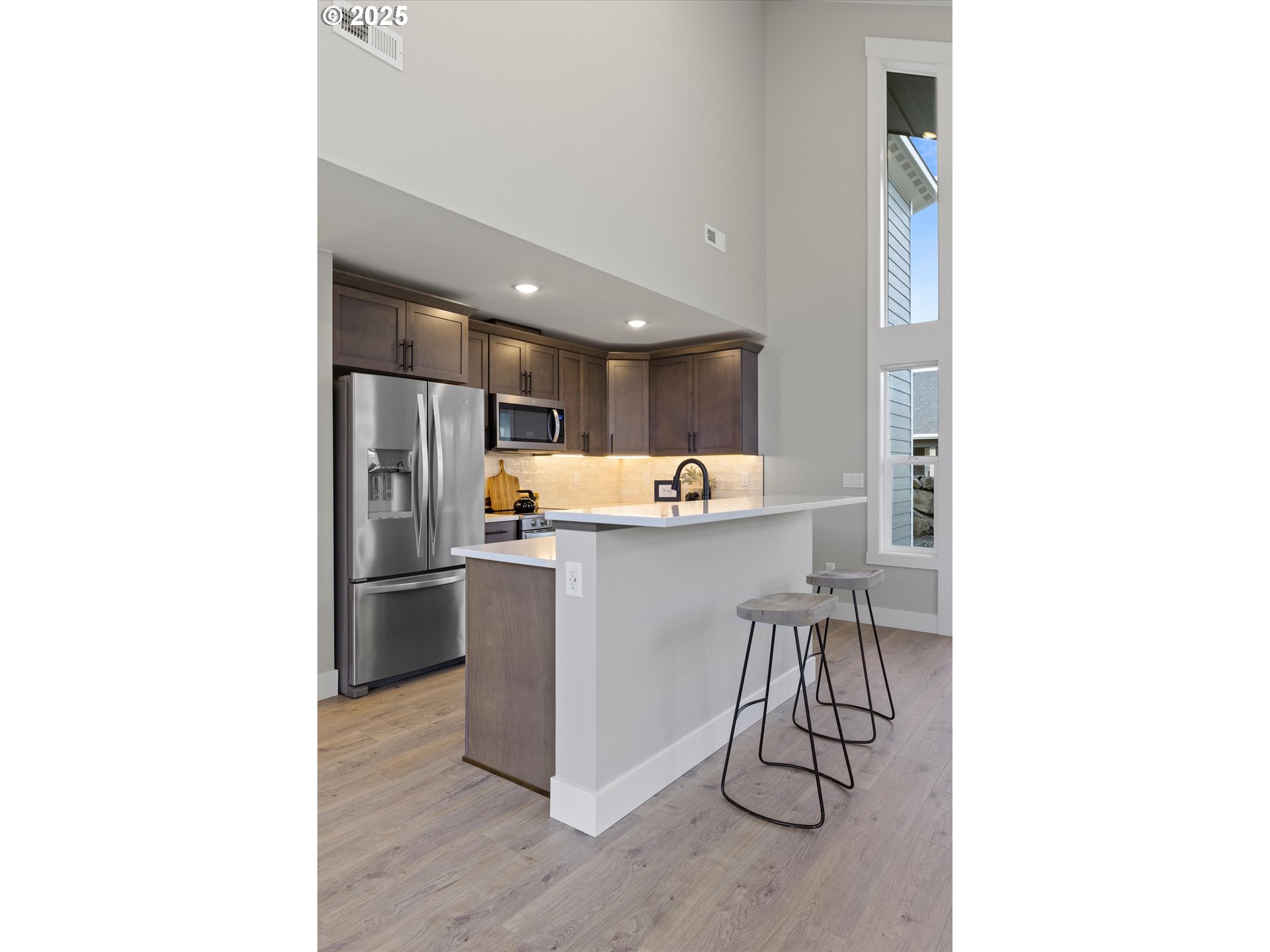 1801 Southwest 1st Street Pendleton, OR 97801 - Photo 8 of 29 a room with stainless steel appliances kitchen island granite countertop a refrigerator and microwave