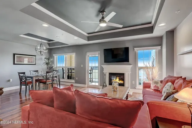 a living room with furniture a fireplace and a flat screen tv