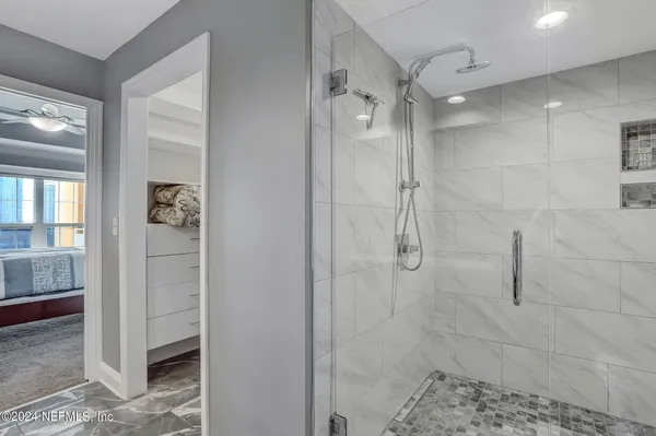 a kitchen with granite countertop a stove a sink and a wooden cabinets
