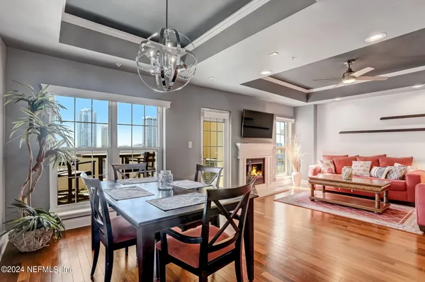 a view of a dining room with furniture wooden floor and a chandelier