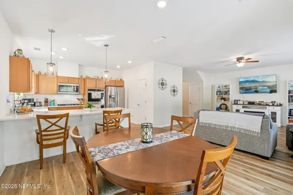 a kitchen with a refrigerator a microwave a sink and cabinets