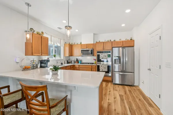 a kitchen with stainless steel appliances a sink stove and cabinets
