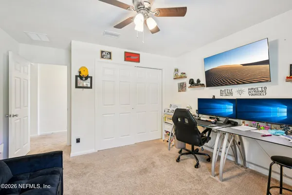 a bedroom with a bed and a tv in it