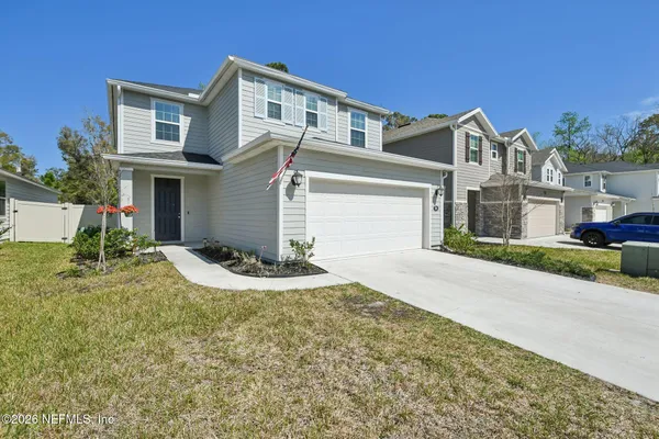 a front view of a house with a yard and garage