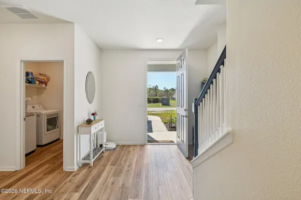 a living room with furniture and a view of kitchen