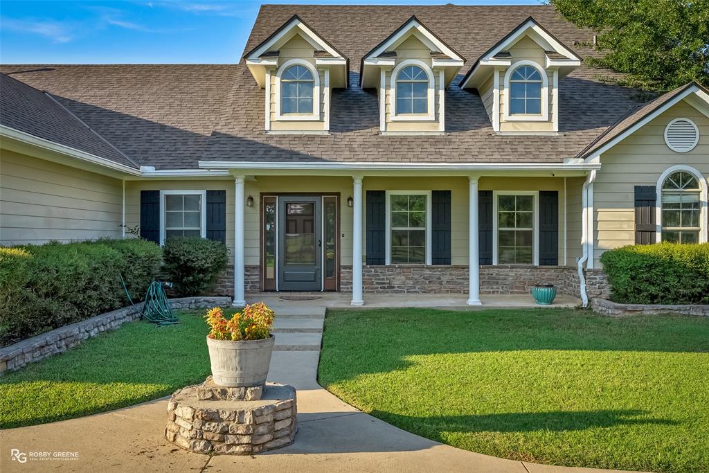 561 Linton Road Benton, LA 71006 - Photo 1 of 1 View of front of property with a shingled roof, a porch, and stone siding