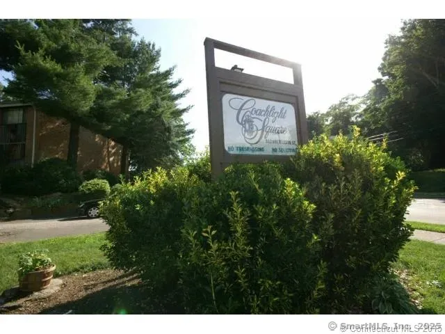 a sign that is sitting in front of flowers