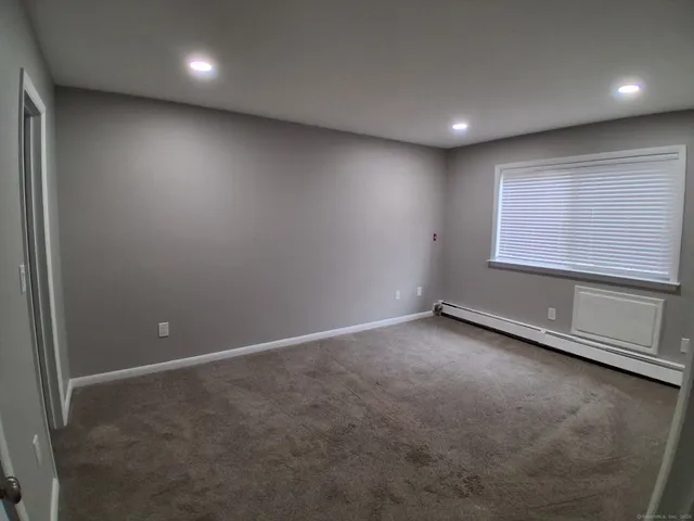 an empty room with a empty space and a window