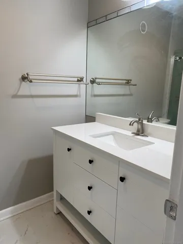 a bathroom with a sink mirror and vanity