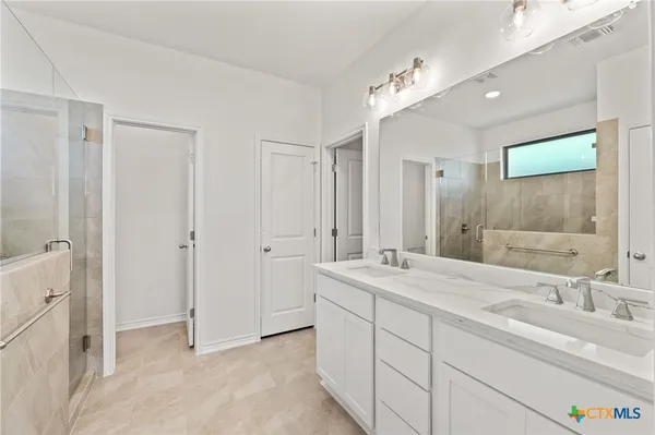 a bathroom with a shower and a sink