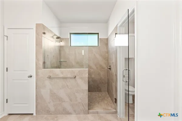 a bathroom with a shower and a sink
