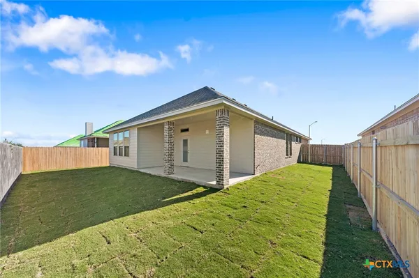 a house view with a backyard space
