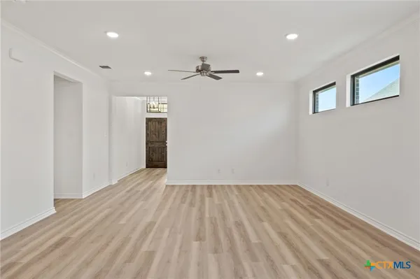 a view of an empty room and wooden floor