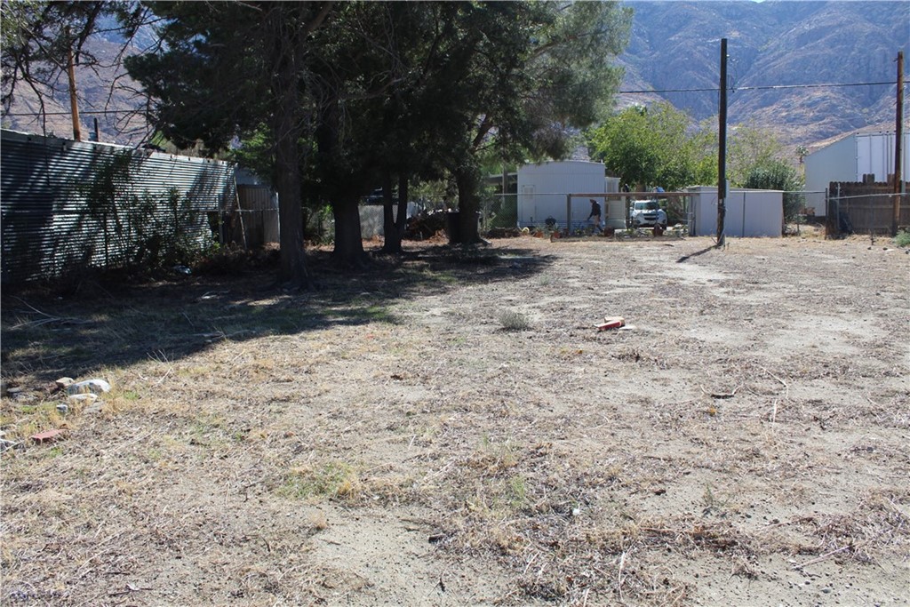 51945 Maxine Avenue Cabazon, CA 92230 - Photo 6 of 21 a view of a yard with wooden fence