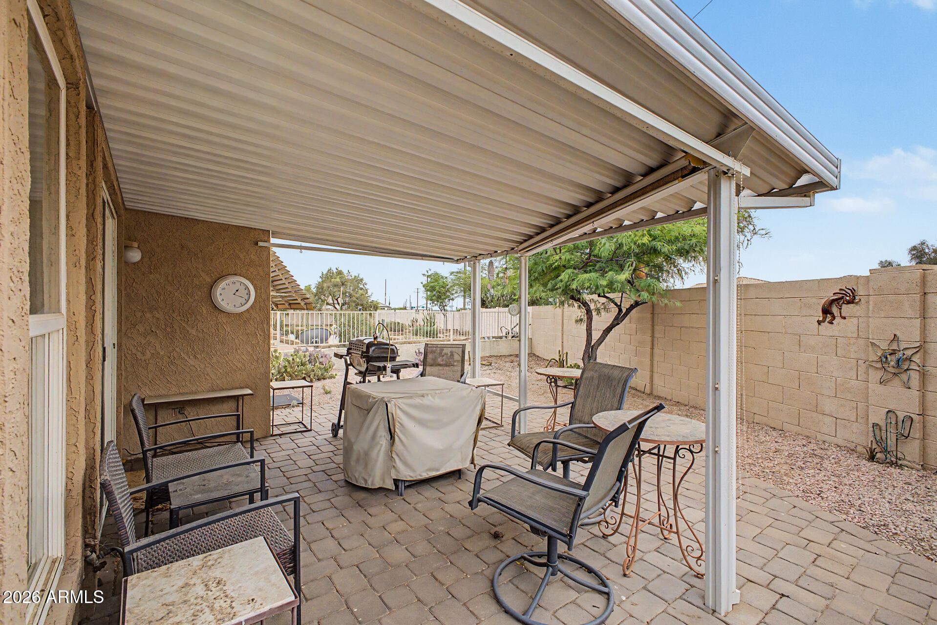 2101 South Meridian Road, Unit 45 Apache Junction, AZ 85120 - Photo 23 of 36 a view of a patio with table and chairs and potted plants