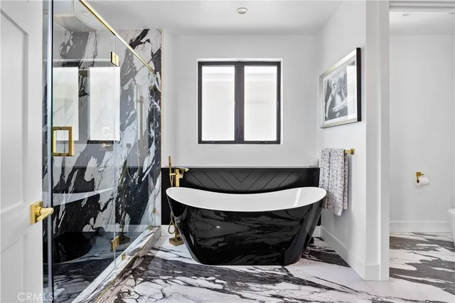 a spacious bedroom with a bed and a chandelier