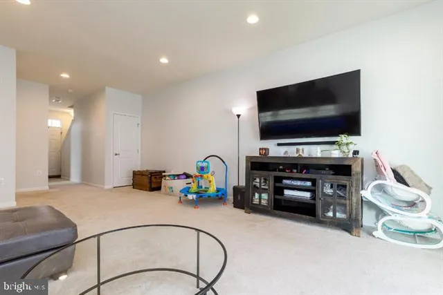a bedroom with furniture and a flat screen tv