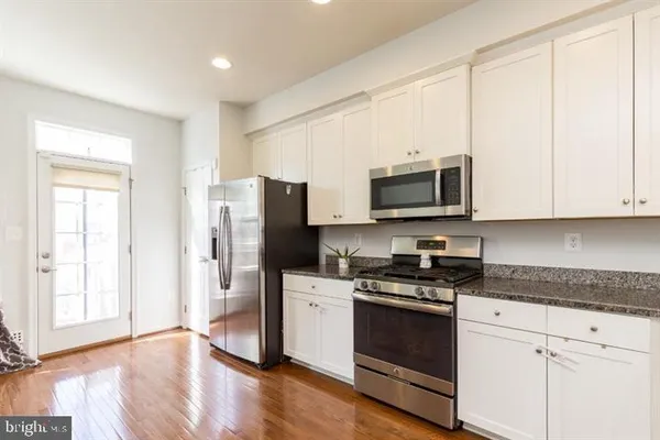 a kitchen with a refrigerator stove and microwave