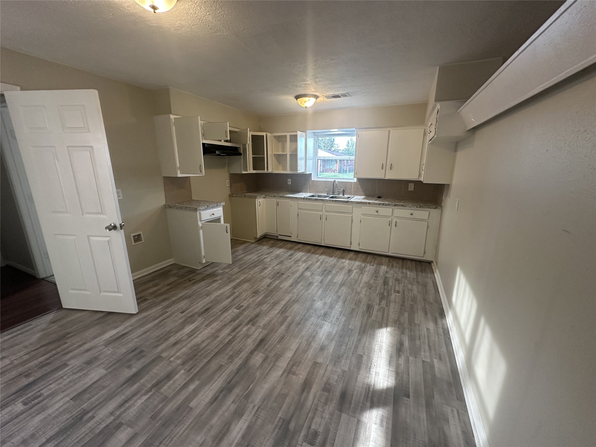 3906 Madden Lane Houston, TX 77047 - Photo 3 of 11 a large kitchen with a wooden floor and stainless steel appliances