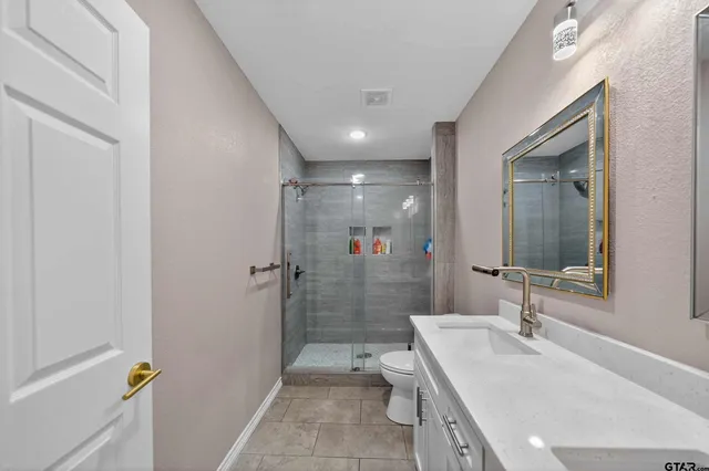 a bathroom with a tub sink toilet and a mirror